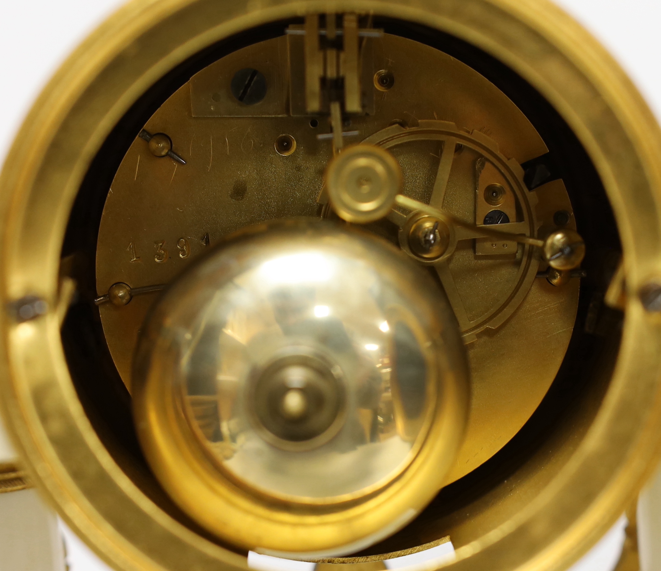 A 19th century French ormolu and white marble clock garniture striking on a gong, the dial decorated with swags, 40cm high